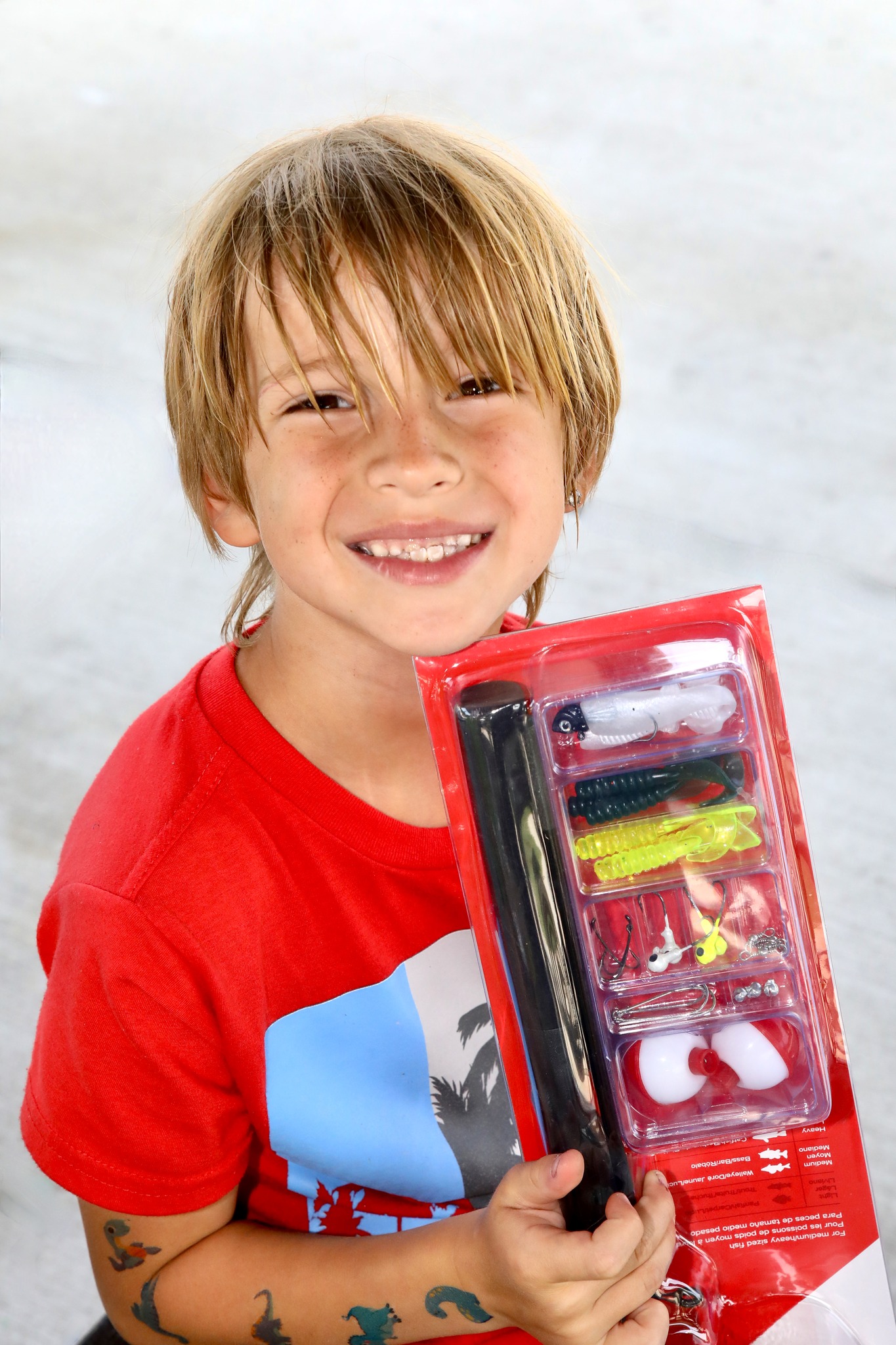 Kid with fishing tackle prize at Family Field Day 2025