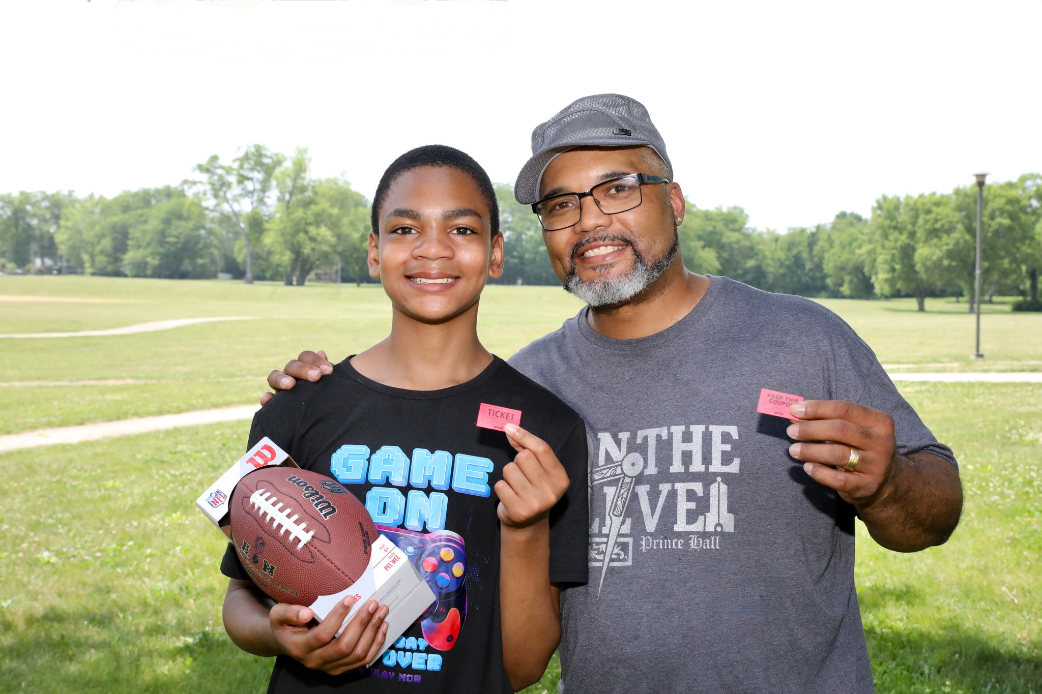 Father and son with prizes at Family Field Day 2025