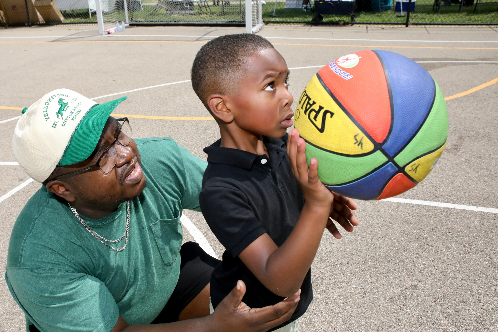 Father and son with toy prizes at Family Field Day 2025